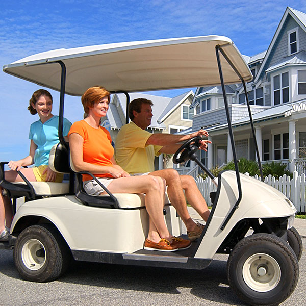 A family riding golf cart on the street